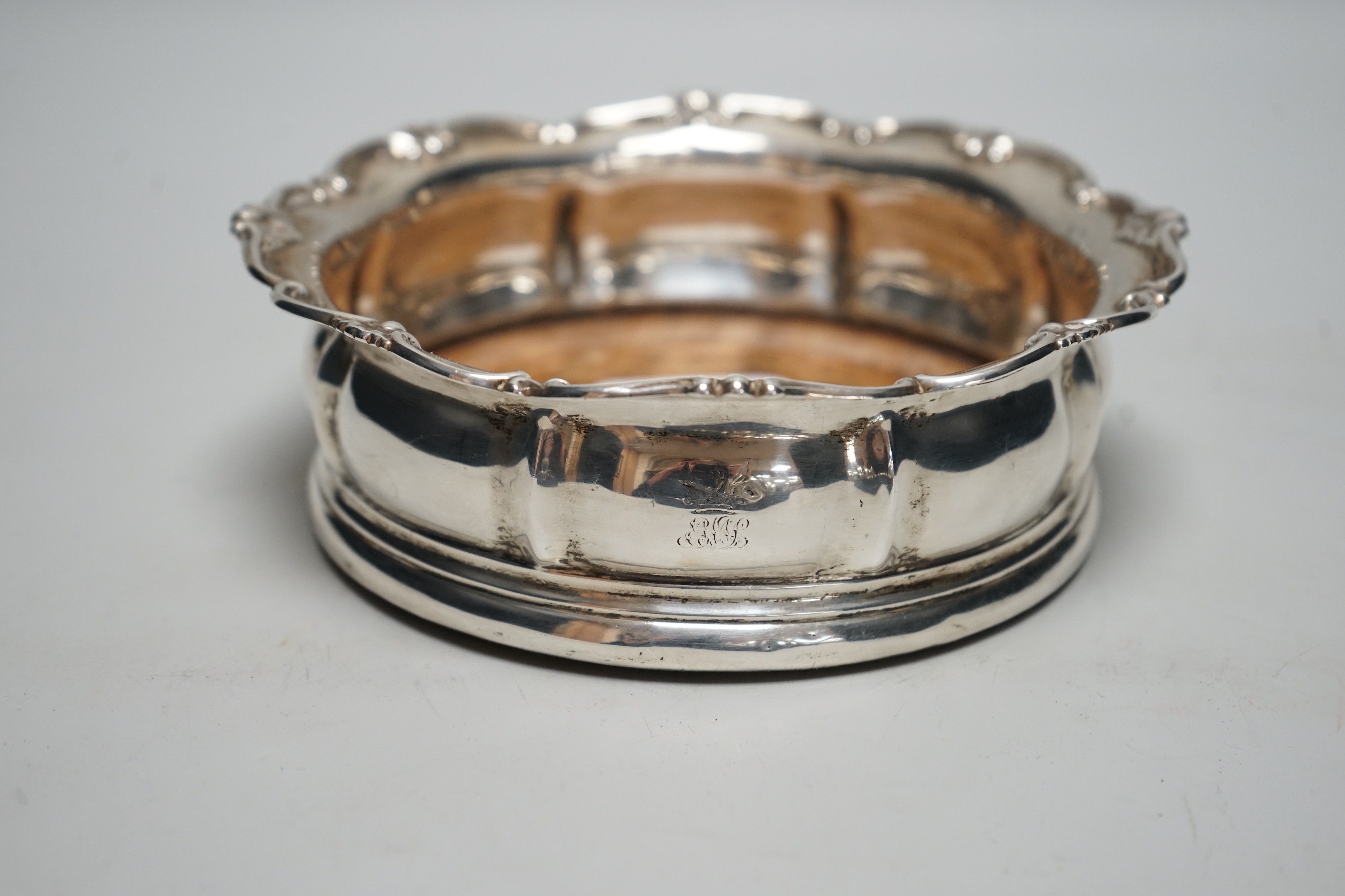An early Victorian silver mounted wine coaster, with scrolling border, marks very rubbed, possibly London, 1838, diameter 16cm.